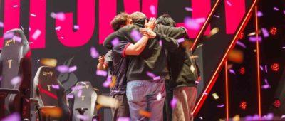 Maryville League of Legends team embraces in a victory hug celebrating a win.